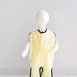 Load image into Gallery viewer, Waterproof full length bib un Sun (yellow). Discover 100% Canadian-made quality, crafted with care & honouring Indigenous beliefs with unique gender-neutral Grass, Water, & Sun hues. Our Waterproof PUL material makes for easy cleanup while two leg loops & adjustable breakaway neck snaps provide full-body coverage & fit a wide range of sizes.