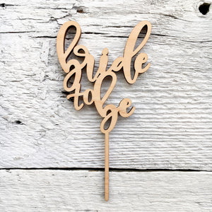 Laser engraved wooden cake topper that says "Bride to Be"