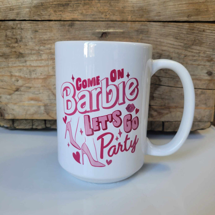 15oz ceramic mug with high heels, hearts, and kissy lips that says "Come on Barbie Let's go Party" in pink lettering. Mug is dishwasher safe but handwash is recommended