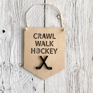 Laser engraved 3D wall flag that says "crawl walk hockey" with hockey sticks
