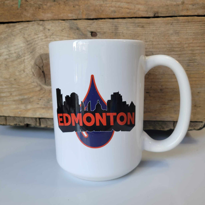 15oz ceramic mug with "Edmonton" in orange black letters, the Edmonton cityline, and the oilers oil drop. The mug is dishwasher safe but handwash is recommended.