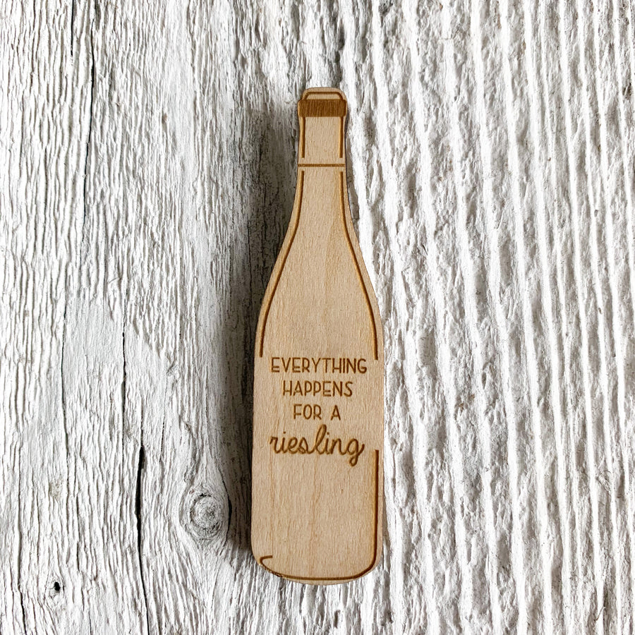 2 inch birch plywood magnet in the shape of a wine bottle that says "everything happens for a riesling".