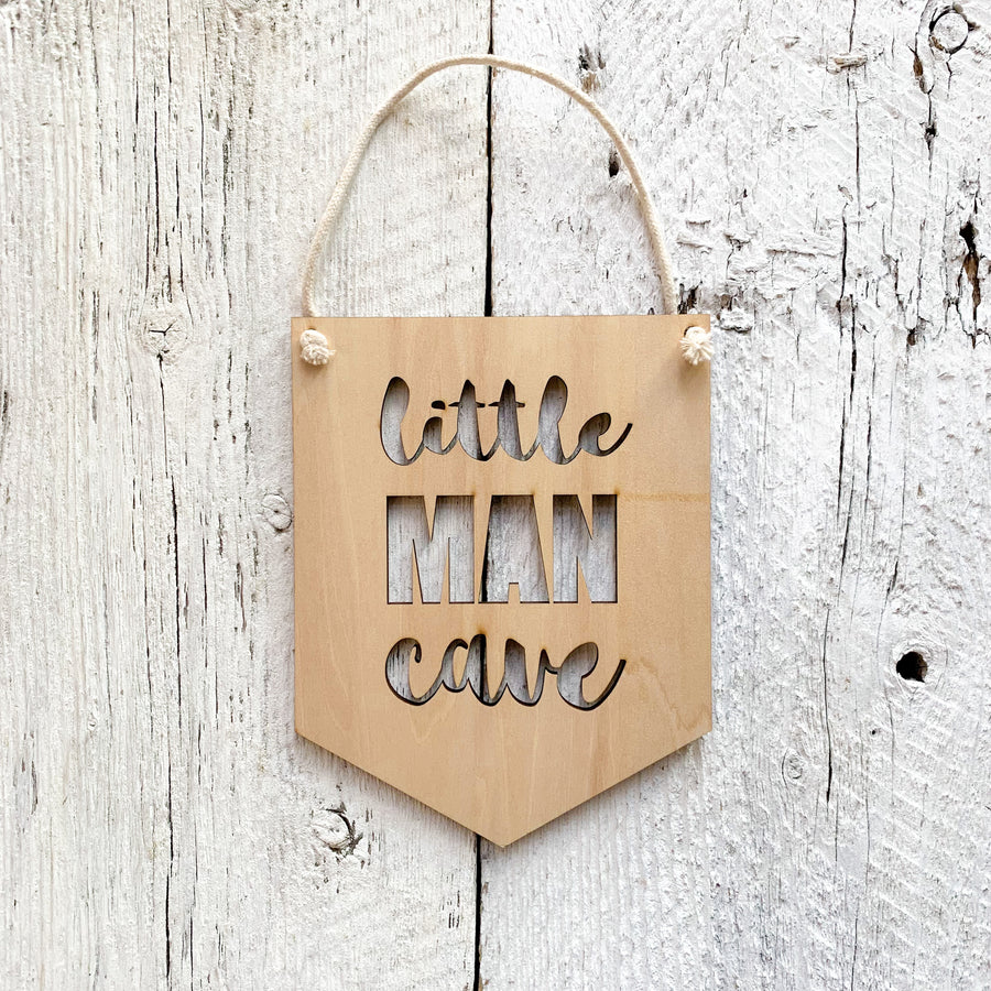 Laser engraved wall flag that says "Little Man Cave".