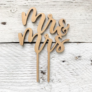 Laser engraved wooden cake toppers that say "Mr. & Mrs."