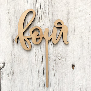 Laser engraved wooden cake topper with the word "four".