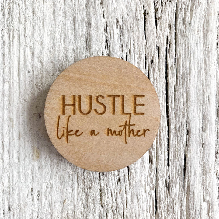 2 inch birch plywood magnet that says "Hustle like a mother" 
