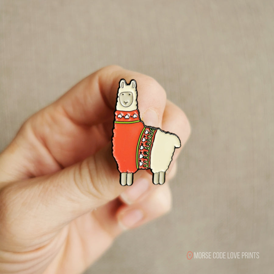 Pin is of a llama wearing a red sweater and measures 1 1/4" along the longest edge. 