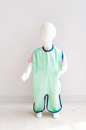 Single Layer Grass (green) full length bib. This single-layer bib gives you the perfect combination of coziness and protection; its lightweight, soft fabric prevents messes from staining your home, and the waterproof polyurethane laminate (PUL) won't shrink or fade even with heavy use. 