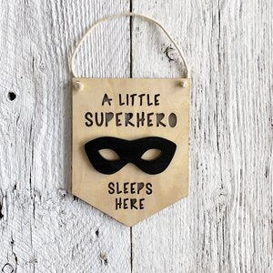 Laser engraved 3D wall flag that says "A little superhero sleeps here" with a superhero mask