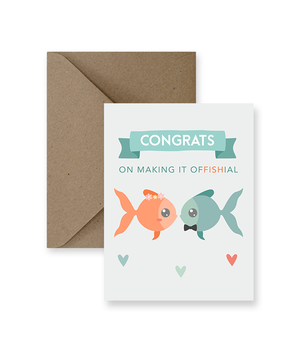 Sized A2, 4.25 x 5.5 inches folded card has a bride and groom fish kissing and says "Congrats on making it offishal". This card comes with a matching Kraft Envelope