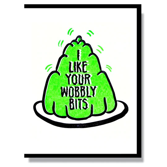 This A2 (4.25” x 5.5”) card is letterpress printed by hand in studio, is blank inside and comes with a black envelope. The front of the card has a plate of green jello and says "I like your wobbly bits" in black lettering. 