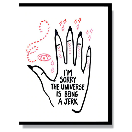 This A2 (4.25” x 5.5”) card is letterpress printed by hand in studio, is blank inside and comes with a black envelope. The front of the card has a mystic hand and says "I'm sorry the universe is being a jerk" on the palm in black lettering.
