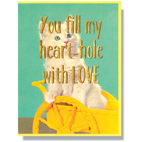 This A2 (4.25” x 5.5”) anniversary/love card is digitally printed with gold foil is blank inside and comes with a yellow envelope. The front has a cat and says "You fill my heart-hole with LOVE" in gold lettering.