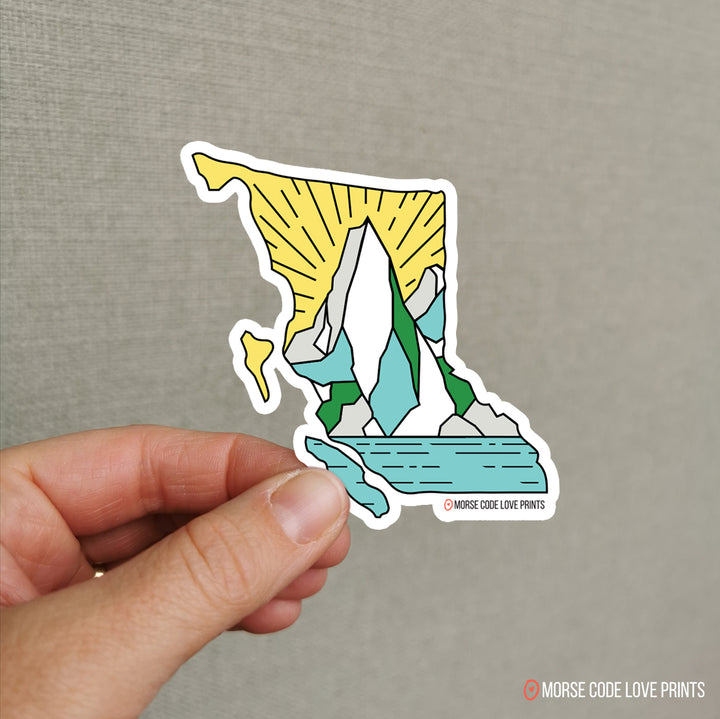 Vinyl sticker in the shape of British Columbia with a beautiful mountain range and water front.