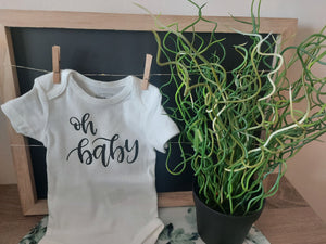 white infant onsie with "oh baby" printed in black HTV vinyl made in Sherwood Park Alberta by All Decked Out Event