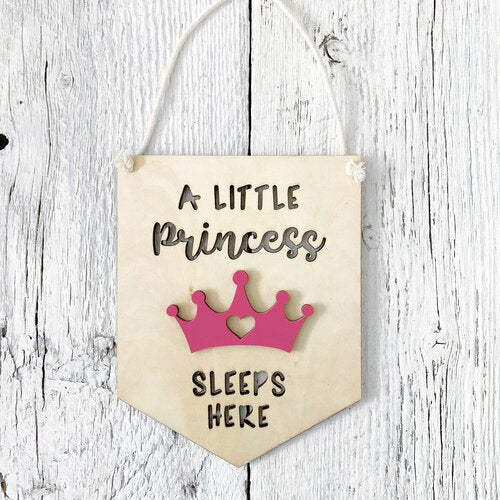 Laser engraved 3D wall flags that says "A little princess sleeps here" with a pink crown