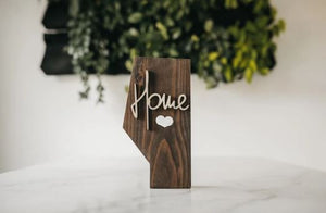 The Alberta board stands 10.5 inches tall and 1.5 inches thick it is made from solid Pine with a smooth walnut stain and protective topcoat finish with the option of raised 'Home' lettering