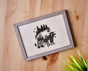 Studio 58 laser engraved "Wild & Free" wooden sign with a bear and forest line